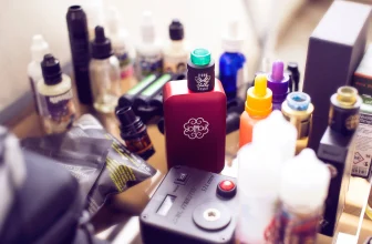 Vape mods, e-liquids and other vaping gear on a table